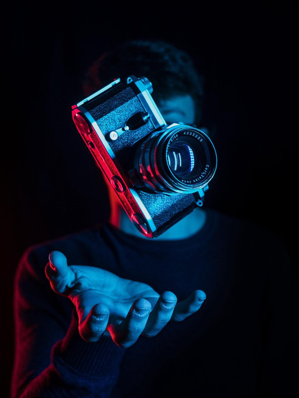 A person holding a camera, demonstrating the importance of choosing content for a successful Youtube channel.