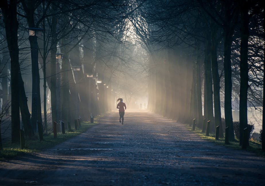 A person jogging outside in the park, representing exercise and weight loss.