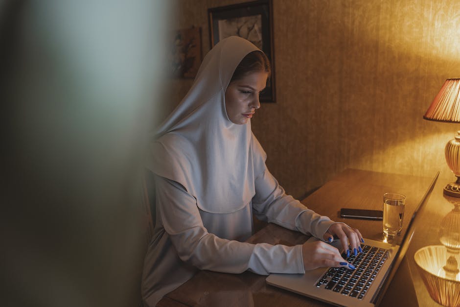 Image of a person typing on a laptop with a stack of money next to it, representing the concept of monetizing writing skills through freelancing.