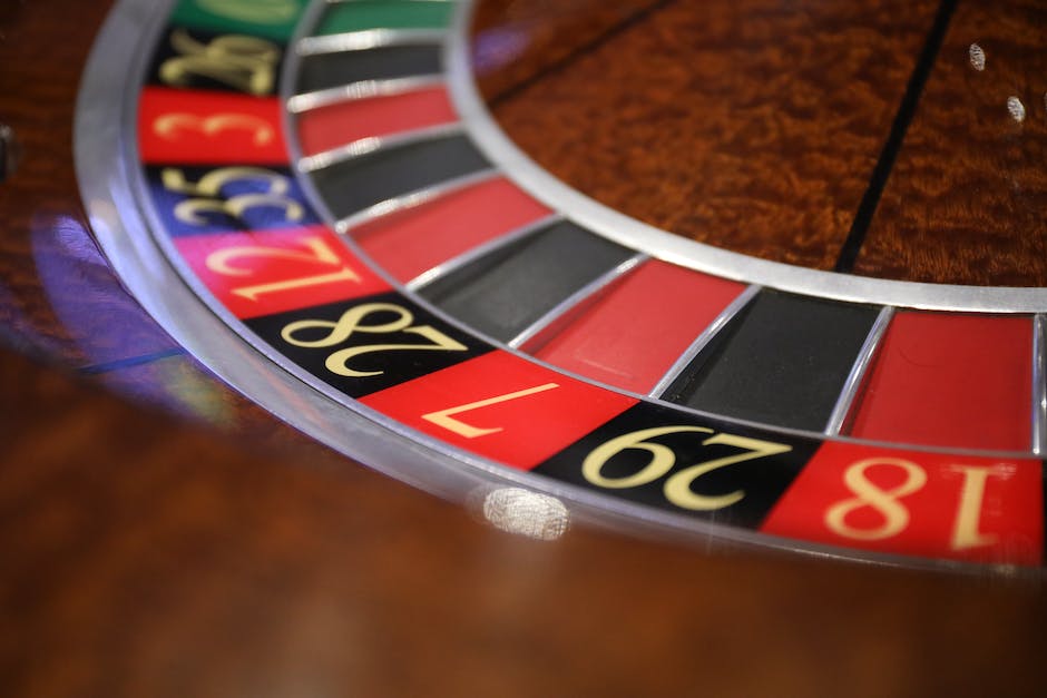 A person placing chips on a roulette table.