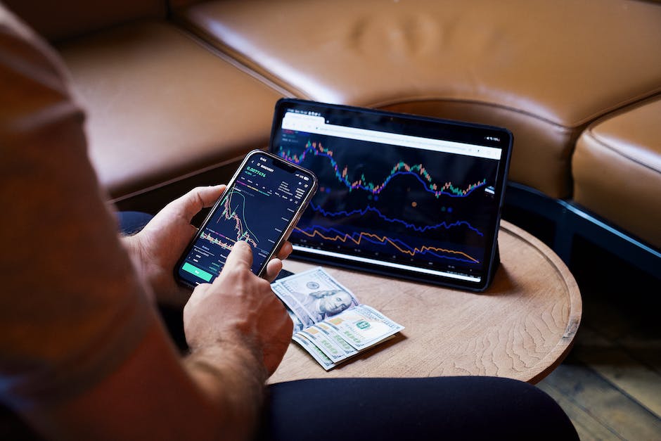 An image showing a person analyzing stock trading charts and graphs.